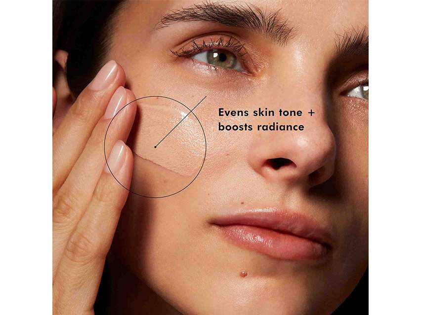 A woman putting on SkinCeuticals Physical Fusion UV Defense Tinted Mineral Sunscreen