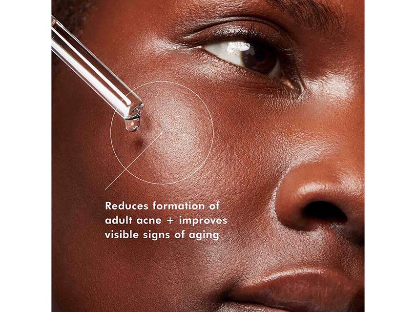 A woman applying SkinCeuticals Blemish + Age Defense Salicylic Acid Serum